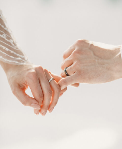 love and tenderness in the wedding couple's crossed hands on the wedding day